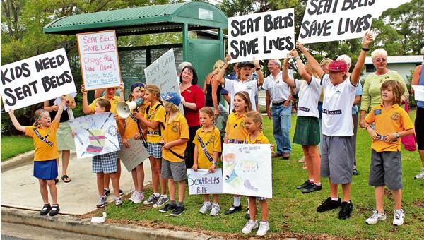 BELT UP: School children join a protest held at Manyana to campaign for mandatory seat belts to be fitted to all rural school buses.

