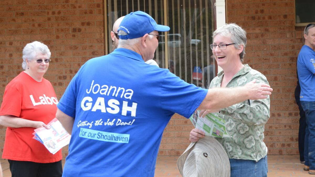 RED, GREEN, BLUE: A Team Gash volunteer greets Greens mayoral candidate Amanda Findley on Saturday.