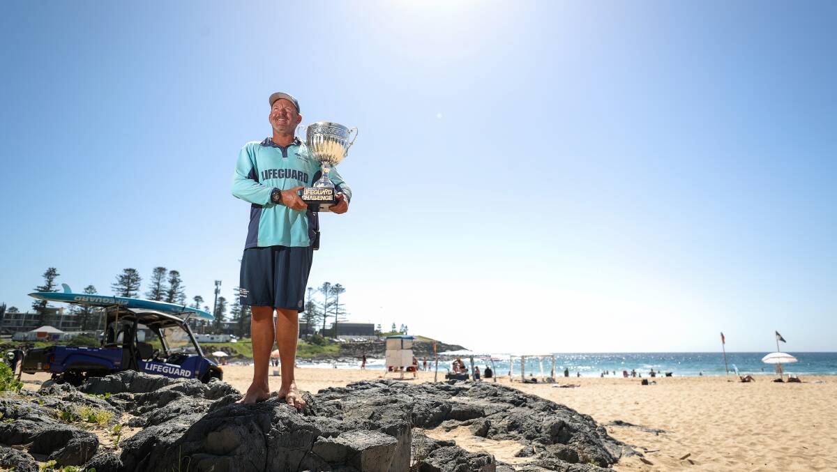 Kiama Municipal Council supervising life guard Craig Bowley with the Illawarra and Shoalhaven Lifeguard Challenge trophy at Surf Beach. Picture by Adam McLean