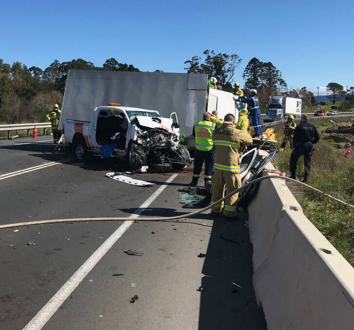 Highway chaos: Fire crew and ambulance crews worked to free the trapped drivers following a head-on crash at Jaspers Brush. Picture: Supplied