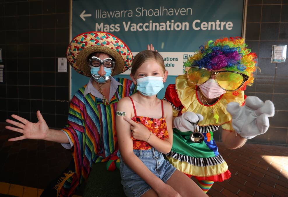 Mass Vaccination Centre staff Luisa Santangelo and Annie Peacock with Aaliyah Sunshine, 10, from Dapto was one of 350 kids to get jabbed during Kids Vaccination Day. Picture: Robert Peet