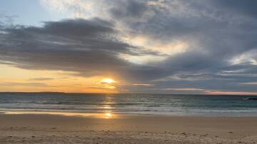 Even on a cloudy morning the sunrise over Mollymook Beach is beautiful.