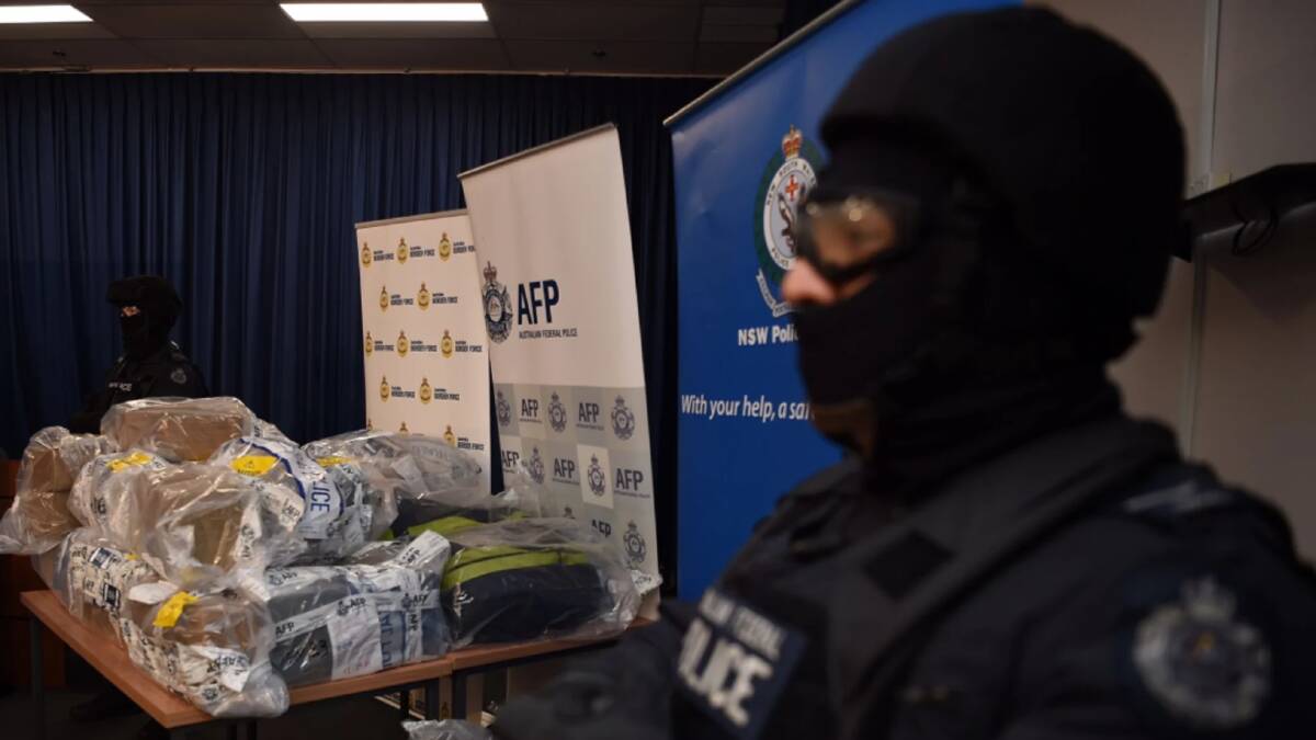 AFP officers stand guard over some of the 500 kilograms of cocaine seized during the Christmas Day bust in NSW. Photo:  Kate Geraghty