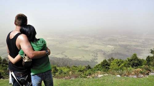 DUSTY VIEW: Tim and Kanako Gatenby from St Georges Basin watching the 2009 dust storm from Cambewarra Lookout. 