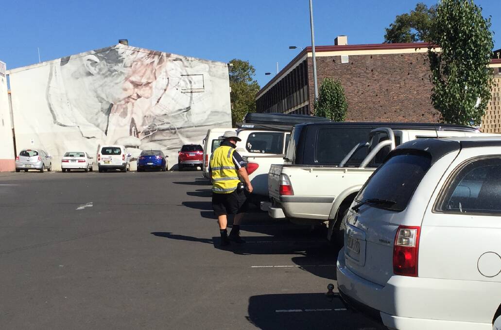 A Shoalhaven ranger patrols the Woolworths car park in Nowra in March.