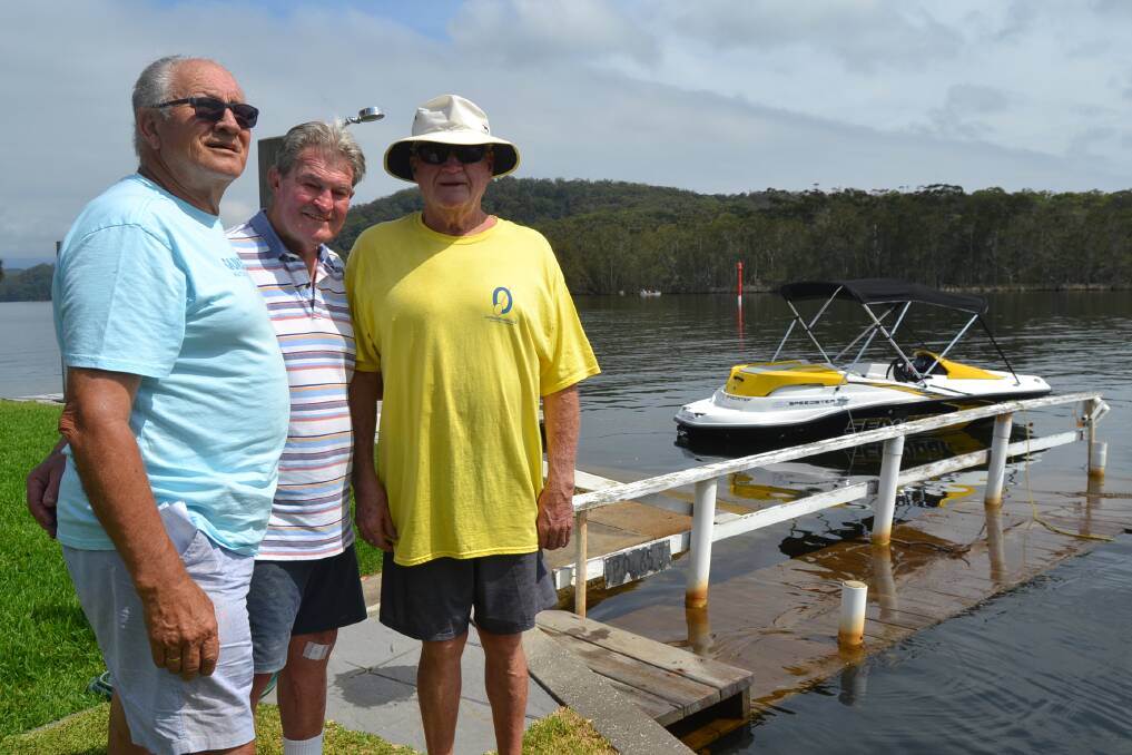 Three best friends and lakeside home owners Hans Van de Haan, John McKelvey and Les Hobbs, pictured beside John's flooded jetty in early January. 