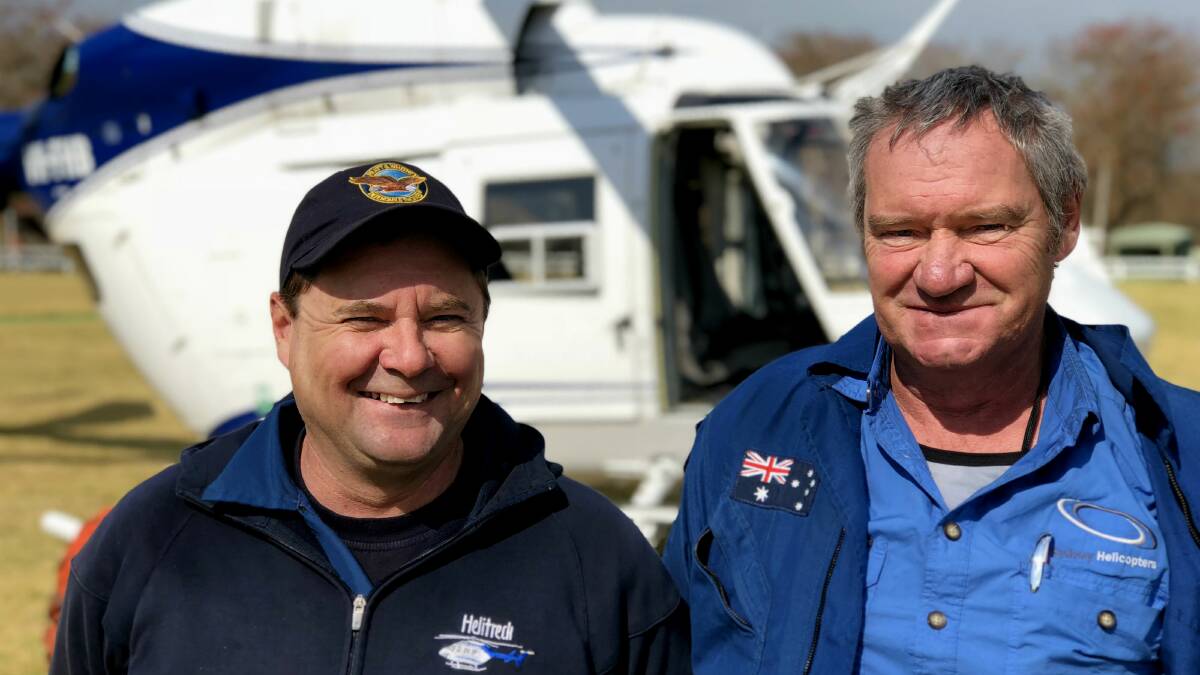 Helicopter pilot Allan Tull (right) just moments before he took off from Milton Showground on what would be his last flight. He is pictured with fellow pilot Kevin Drake, who was also fighting the Kingiman fire from the air. Picture: John Hanscombe