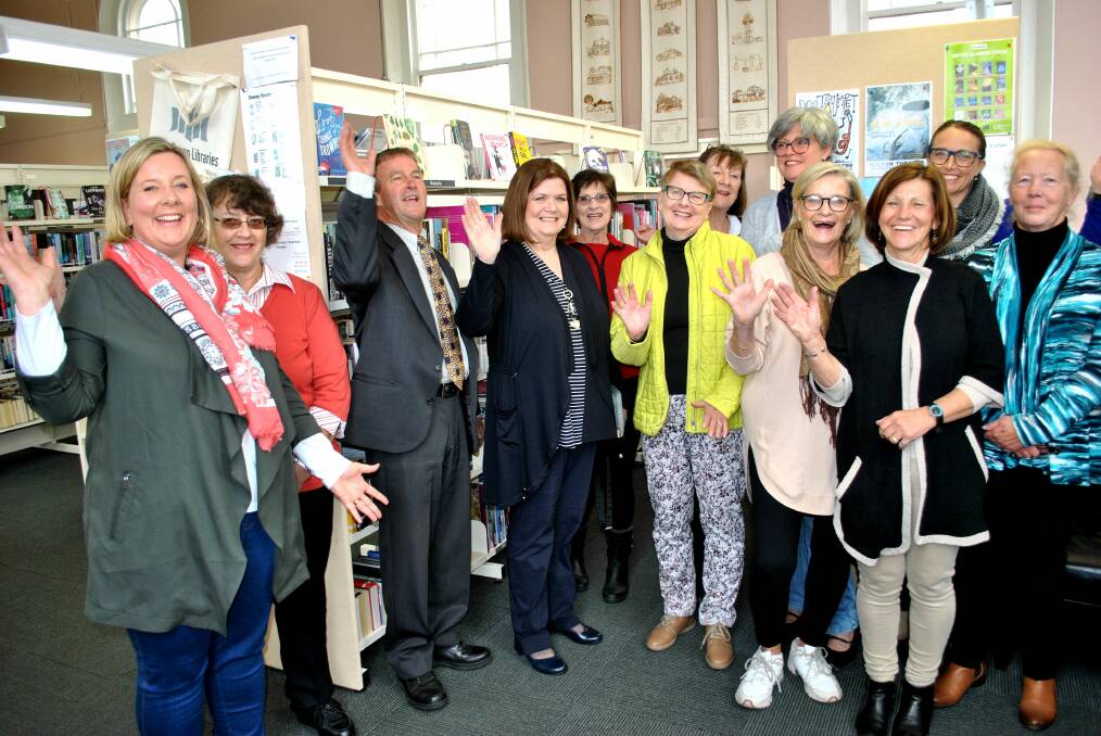 Friends of Milton Library President Alison Pakes (left) and South Coast MP Shelley Hancock (centre) celebrate the funding announcement with library volunteers. Photo: Emily Barton. 