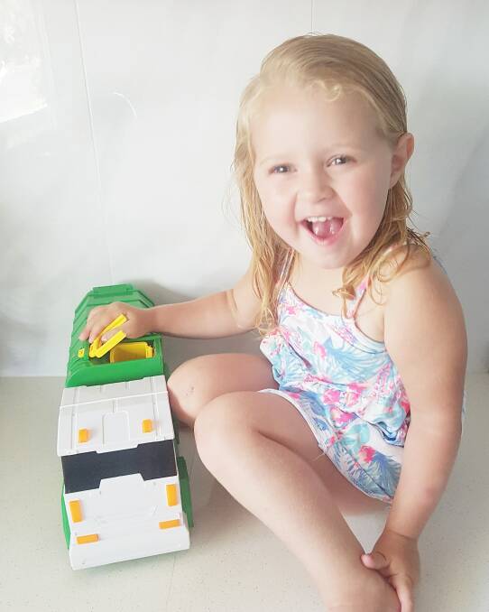 Three-year-old Bexley, of Lake Conjola, was thrilled to be given a toy truck by her garbage man. 