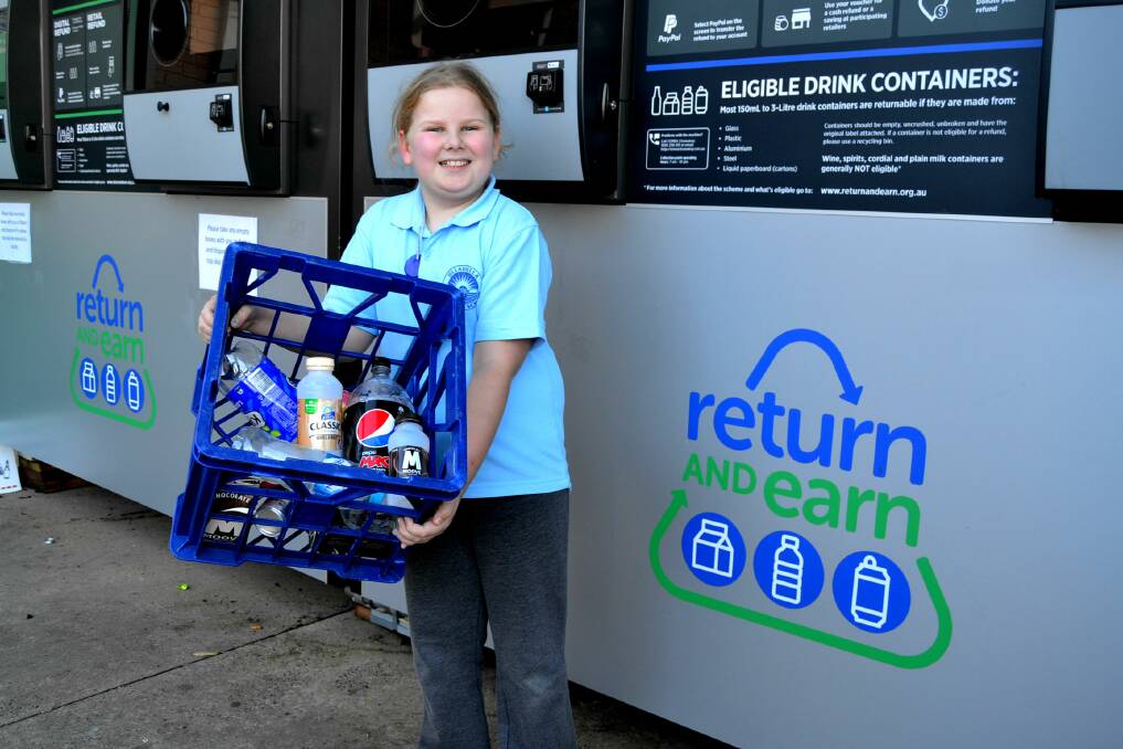 RECYCLING EFFORT: Paige Rutherford is encouraging her Ulladulla Public School classmates to collect their rubbish and recycle it at a Return and Earn reverse vending machine. Photo: Emily Barton. 