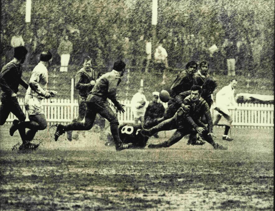 Imagine playing in this. City first versus Country firsts. Sydney First five-eighth, Tony Branson formerly from Nowra, is tackled by Terry Pannowitz and another Country player but gets his pass away to Ron Costello. May 22, 1971. (Photo: John Patrick O'Gready/Fairfax Media).