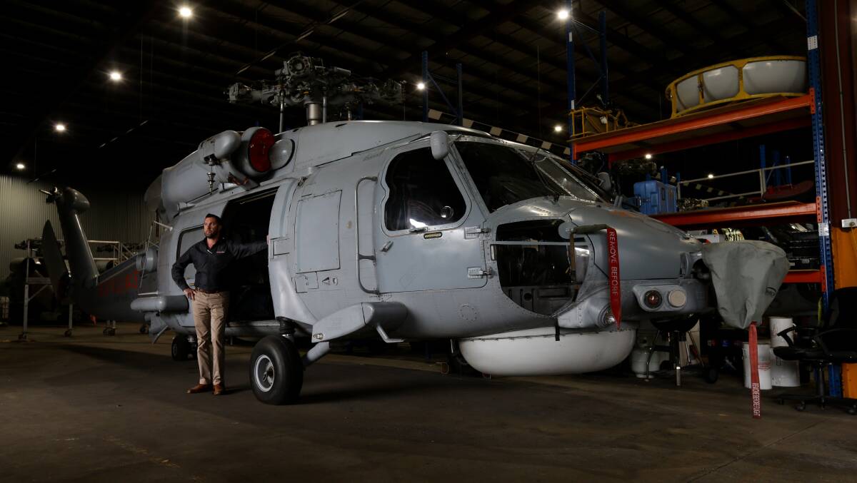 NEW USE: Mat Edwards alongside Skyline Aviation Group's ex-Navy Seahawk helicopters. Photo: Jonathan Carroll