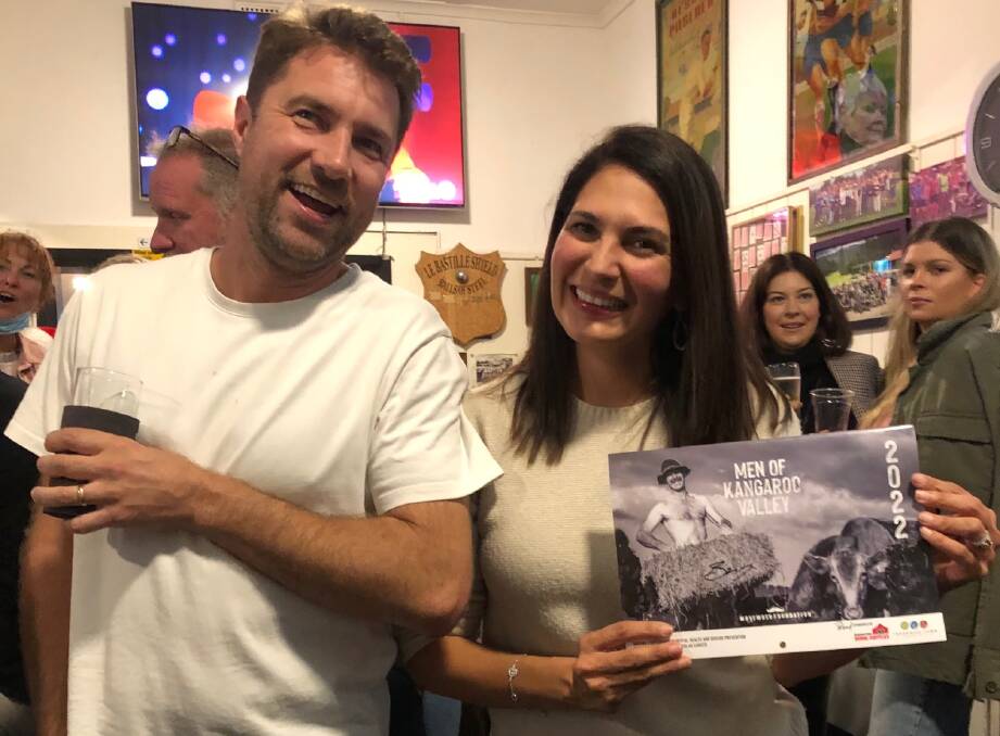 STAR: Mr and Mrs May, Sam and Cecilia Brewer with a signed auction calendar at Fridays launch of Men of Kangaroo Valley 2022 calendar. Image: Supplied