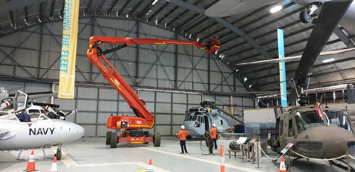 HUGE JOB: A cherry picker with a 125 foot boom made for some spectacular images as its massive arm stretched across the museum to allow for the lighting change at the Royal Australian Navy Fleet Air Arm Museum. Image supplied