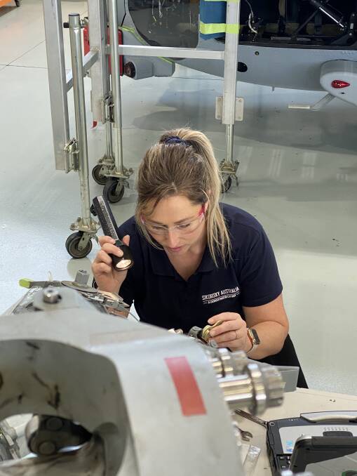 INSPECTION: Sikorsky Australia's sustainment and maintenance technician for the MH-60R Seahawk maritime helicopters, Yvette Payne, inspects rotary component parts. 