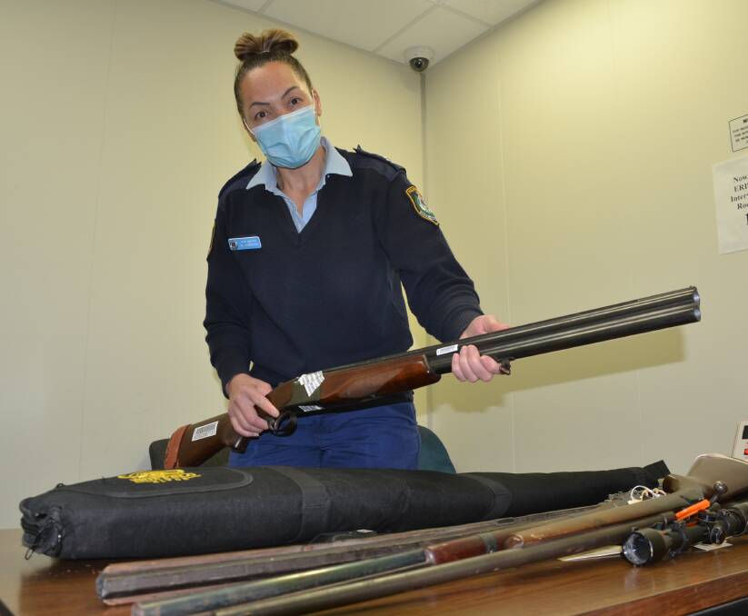 VARIETY: South Coast Police Nowra station exhibits officer Senior Constable Michelle Hammond with some of the guns that have been surrendered as part of the gun amnesty.