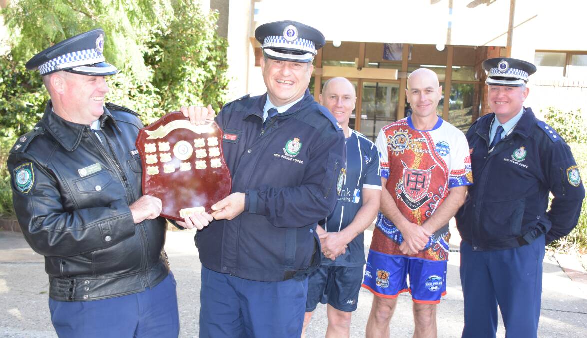 ITS MINE: Lake Illawarra Acting Superintendent Dean Smith and South Coast Acting Superintendent Kevin McNeill battle over the Steven 'Jonno' Johnson Memorial Shield which will be played for this Sunday watched by Lake Illawarra Sergeant Nick Park, Nowra Detective Senior Constable Jason Angus and officer in charge of Nowra station Inspector Ray Stynes.