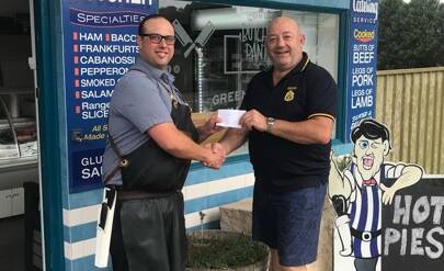 SUPPORT: Bryce Warnock from South Coast Butchers Pantry at Greenwell Point presents Nowra RSL Sub-Branch treasurer Craig Shannon with $250 raised from the butchery pie sales on Anzac Day.