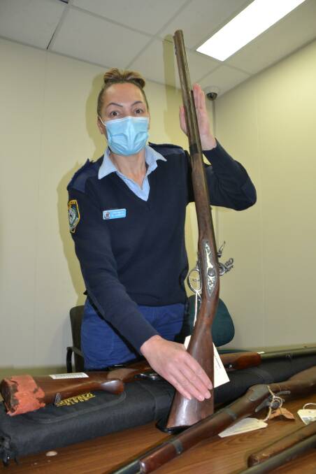 DIFFERENT: South Coast Police Nowra station exhibits officer Senior Constable Michelle Hammond with a musket that has been surrendered as part of the gun amnesty.