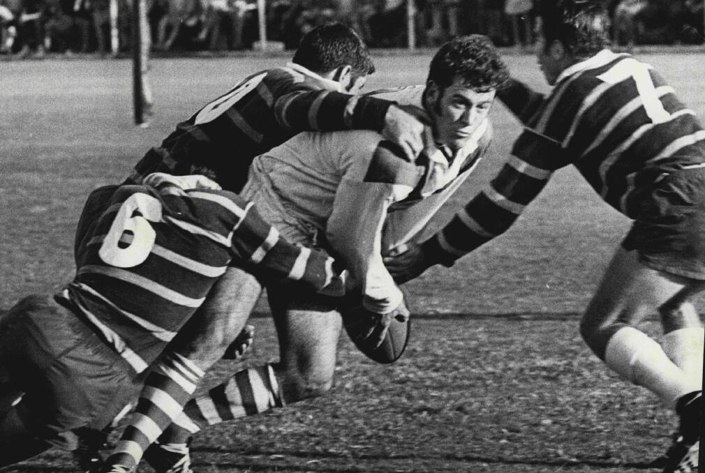 Tony Branson is swamped by three Parramatta defenders at Kogarah Oval. March 8, 1970. 