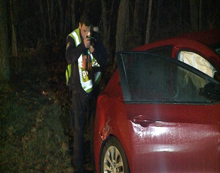 INVESTIGATION: A NSW Police crash investigator at Friday night's fatal accident at Wandandian. 