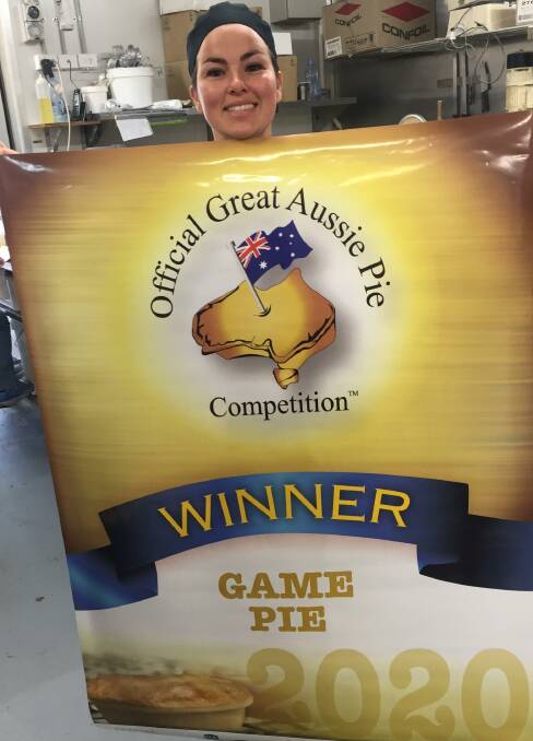 PROUD: Bakehouse Delights pastry chef Mikayla Brightling proudly shows off the Best Aussie Pie Competition champion game pie banner.
