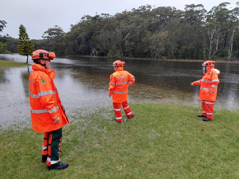 ON STANDBY: Ulladulla SES members inspect some of the flooded areas around Lake Tabourie. Photo: Ulladulla SES
