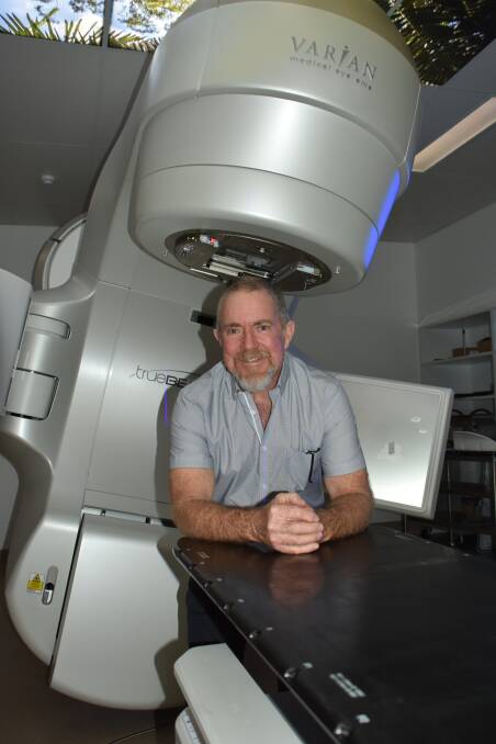 Ulladulla man Gordon White with the linear accelerator at the Shoalhaven Cancer Care Centre. 