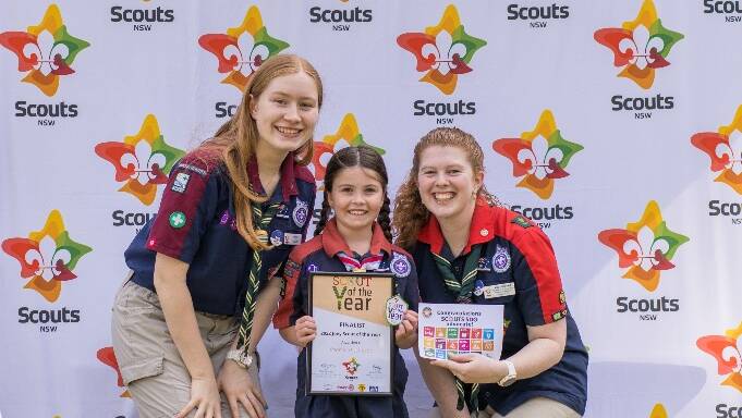 Pepper Thompson (centre) receives her award as the 'People's Choice' winner of Scout of the Year for 2022. 