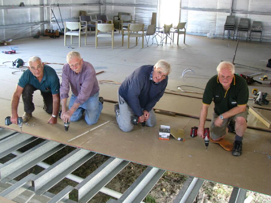 MUMRC members Vince Rowe,  John Katsoulis, Peter Walker and Geoff Millard installing the interior flooring in the South Coast Railway History Museum. Picture: supplied.