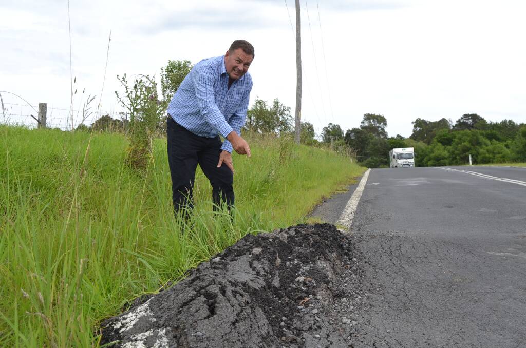 ROAD WORRIES: Milton businessman Grant Schultz is concerned the growing pothole and rising tar could cause a fatality on Matron Porter Drive. 