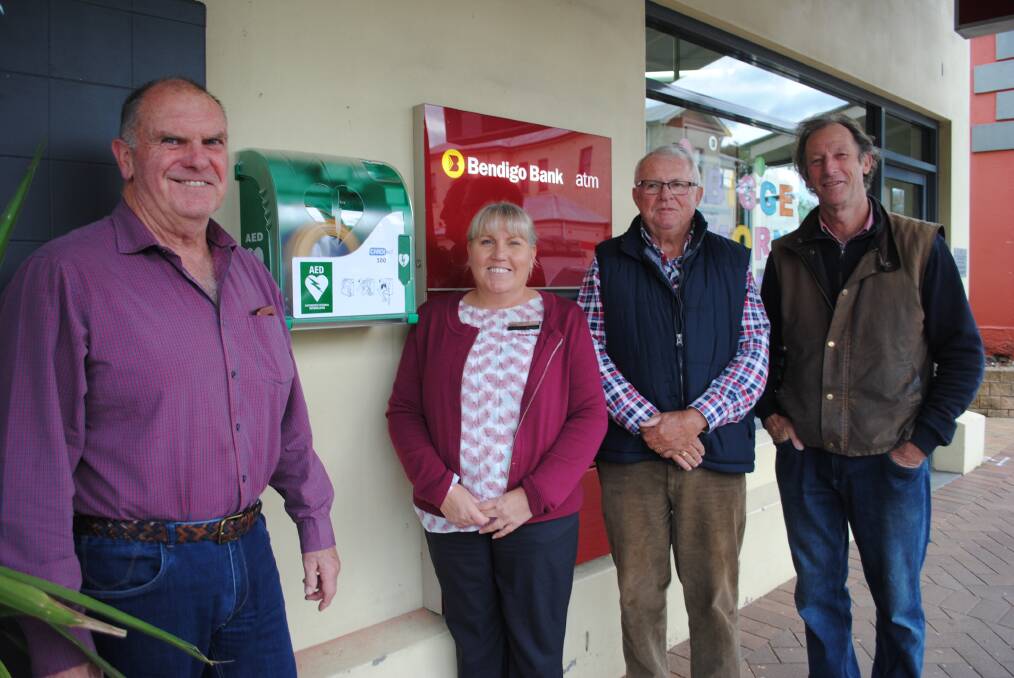 Men's Health and Cancer Support Group members Peter Still, Tony Hardman and John Schuttle with Bendigo Bank's customer relationship manager Caroline Boland.