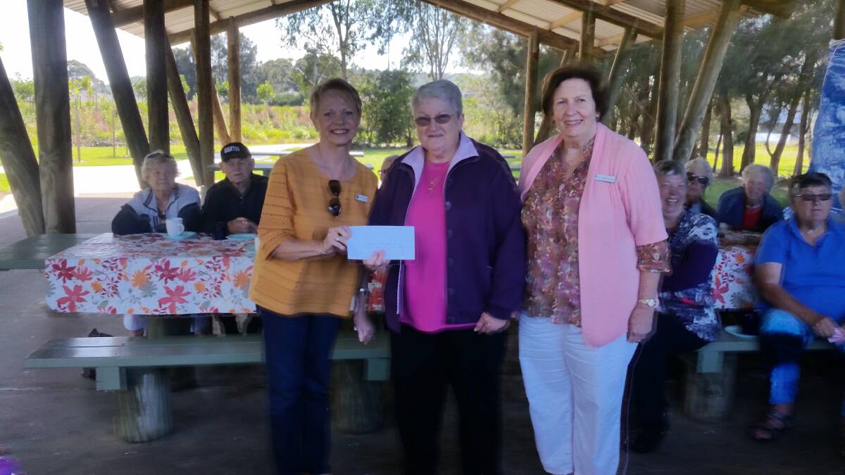 Uniting Church memebrs Christine Grimaldi and Fay Kastelein hand a cheque to Ulladulla Stroke Recovery Club treasurer Ann Hoffman at Burrill Lake. 