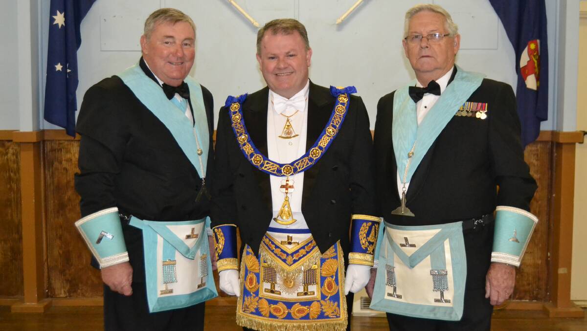 HAND OVER: United Grand Lodge of NSW and the ACT grand master James Melville (centre) visited Milton Masonic Lodge for the installation ceremony of Allan Went (right), who took the reins from Keith Claxton. Picture: Emily Barton.