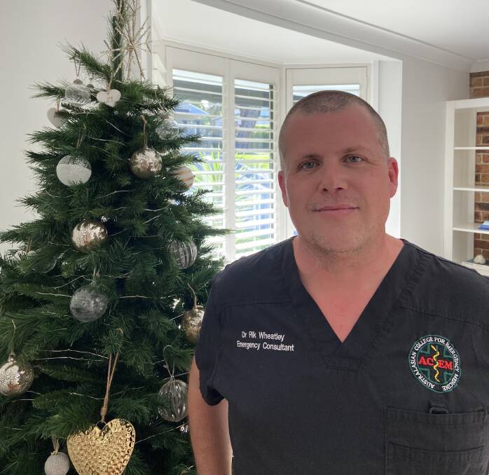 Dr Rik Wheatley is pictured beside a Christmas tree. Picture: supplied 