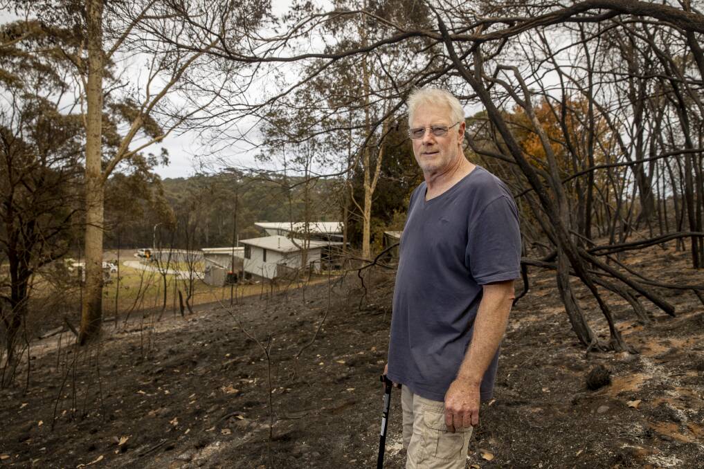 Barrie Curtis stands where a bushfire threatened his Bawley Point home on Thursday. Picture: Sitthixay Ditthavong