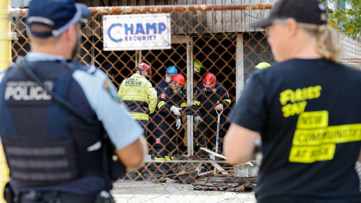 Fire investigators at the scene in Port Kembla on Wednesday. Picture by Anna Warr