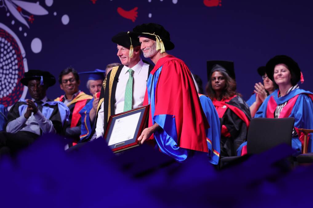 Craig Foster is admitted as an honorary Doctor of Laws by deputy chancellor Robert Ryan. Picture by Sylvia Liber