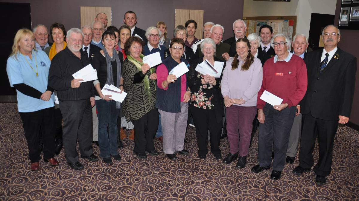 GIFT OF GIVING: Representatives from the area’s community organisations accept their donations in 2014 from the Milton Ulladulla Bowling Club, Milton Ulladulla Ex Servos and the Mollymook Golf Club. File image.