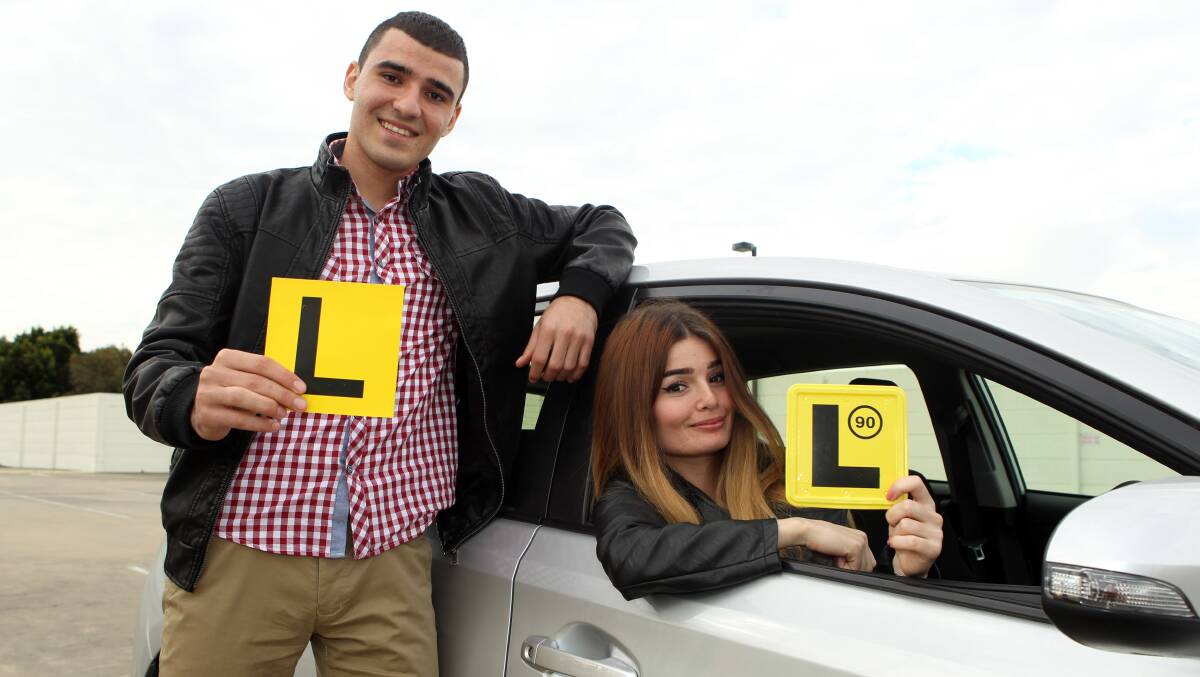 DIGITAL: Learner drivers will now manage their log books online. Photo:  Shows Awia and Babel Youkhana by Chris Lane for Fairfax Media.