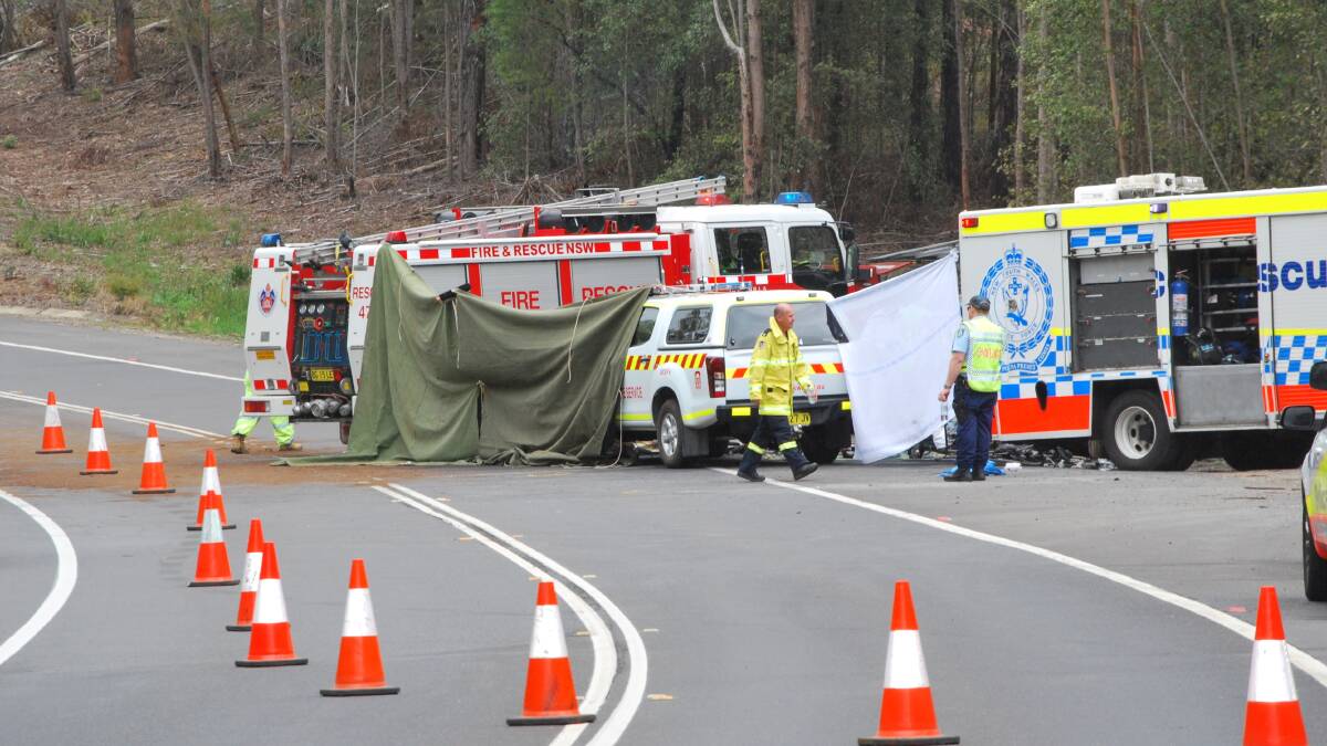 Emergency services at the scene of the fiery Boxing Day crash on the Princes Highway, north of the Bendalong turnoff. Five people died as a result of injuries sustained when a driver crossed onto the wrong side of the road and collided head-on with another car. 
