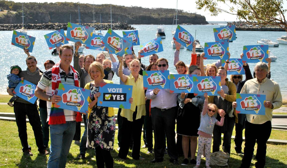 PROUD: Roger Nee and Emily Jenkins stand in front of a group of Milton-Ulladulla businesses who have united to publicly support the "yes" vote. Photo: Jessica McInerney. 