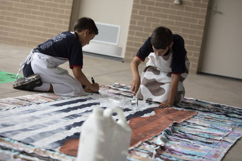 All hands on deck. Senior students prepare their 150th Anniversary Banner for the Milton Show.