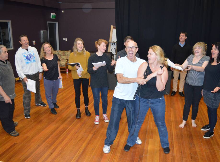 LEADS: Lloyd McDonald and Elissa Skinner practice their musical numbers at the high school hall last week with support from the cast. Photo: Ruth Myers.