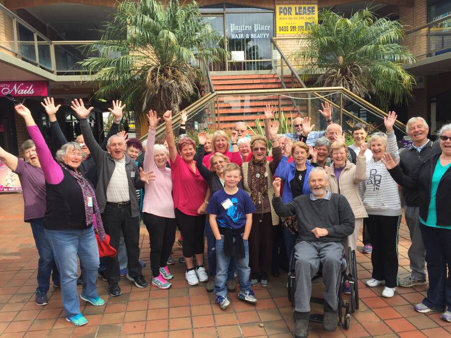 HAPPY DAYS: Happy Feet Walkers were overjoyed to see their friend Rudi Welsh return to Ulladulla today and surrounded him in his wheelchair cheering.