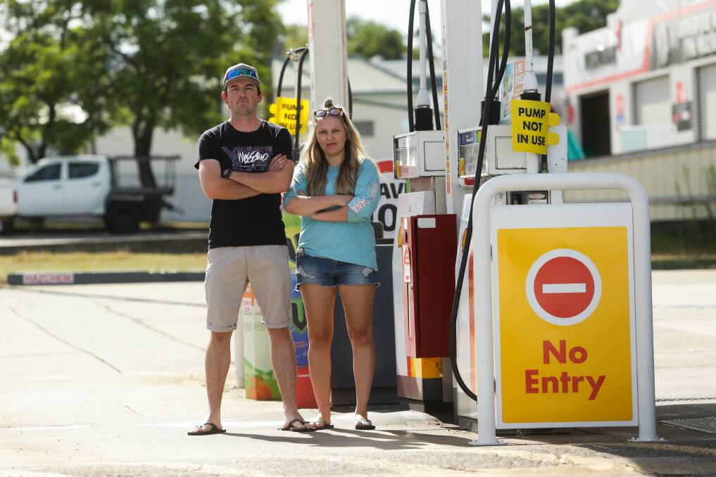 OUT OF POCKET: Joel Stemp and Karina Tolmie at the Coles Express service station in Rutherford. Picture: Jonathan Carroll