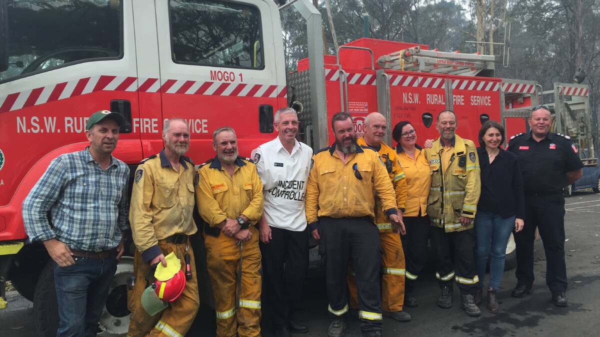 Mogo RFS brigade with Bega MP Andrew Constance, RFS incident controller Mark Williams, NSW Premier Gladys Berejiklian and NSW Fire and Rescue commissioner Paul Baxter.