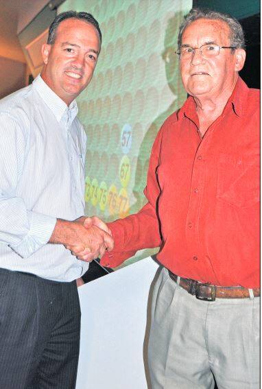 MEMORIES: Mayor Paul Green congratulates Barry Harper, promoter and caller for Charity Cash Bingo, on raising $300,000 for the linear accelerator and accommodation units for the planned cancer care centre in 2011. 