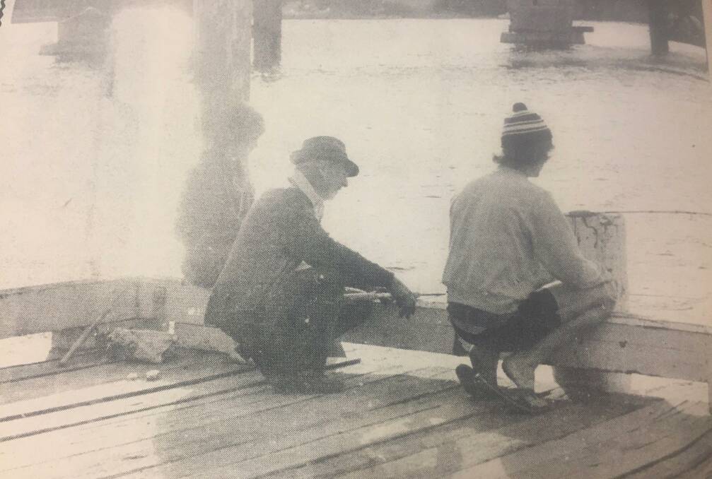 Fishing at sunset from the Nowra Sailing Club wharf at the Shoalhaven River. Photo: Shoalhaven Historical Society.