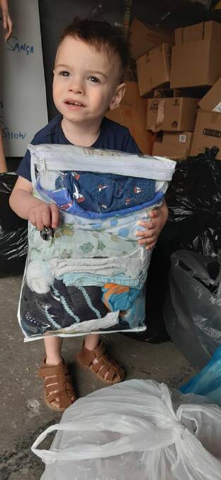 Two-year-old Connor drops off some of his pre-loved baby items to be donated to bushfire victims. Photo: supplied. 